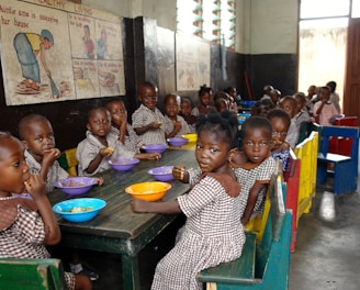 children sitting on green chair eating