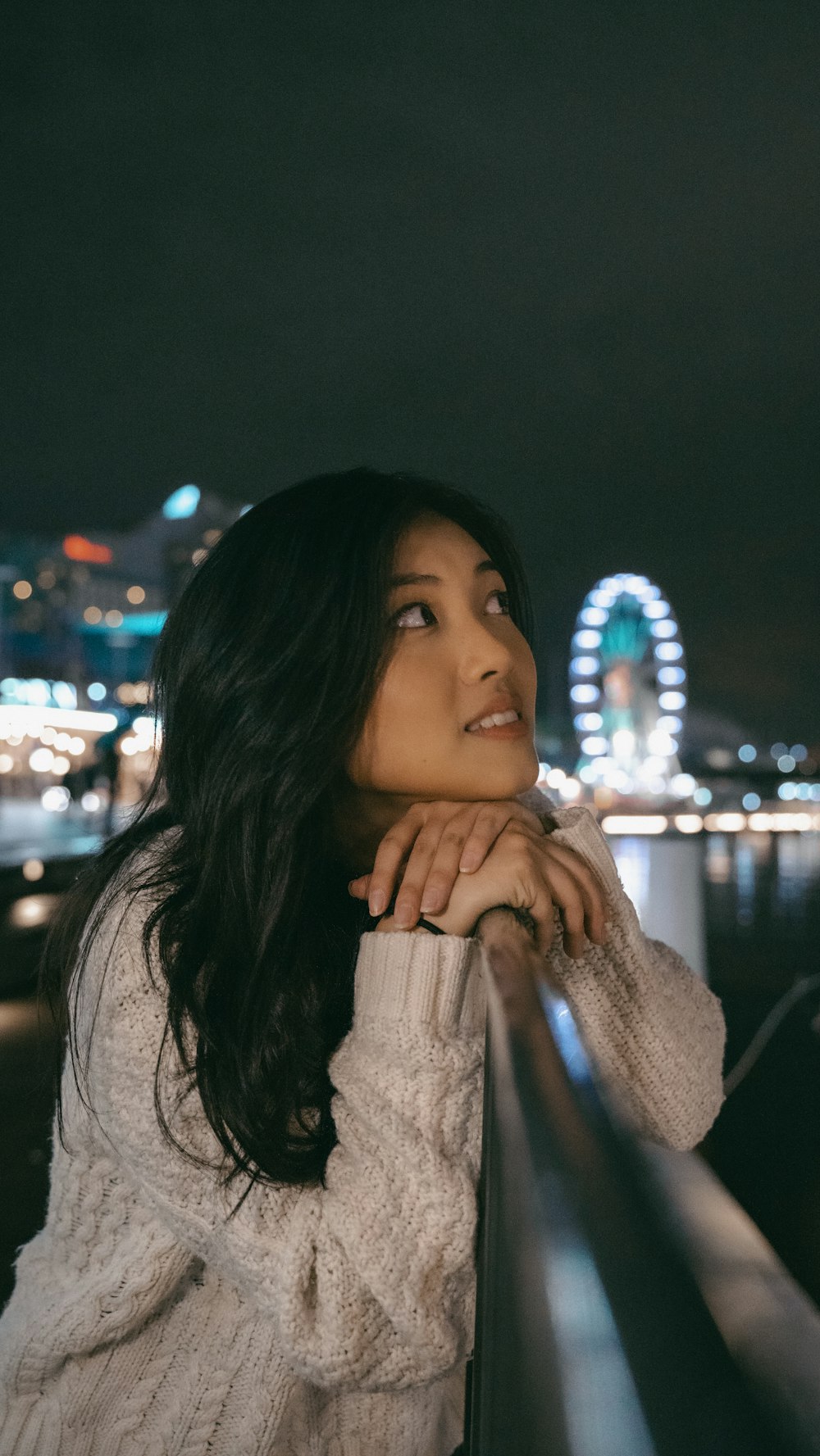 woman in white long sleeve shirt covering her face with her hand