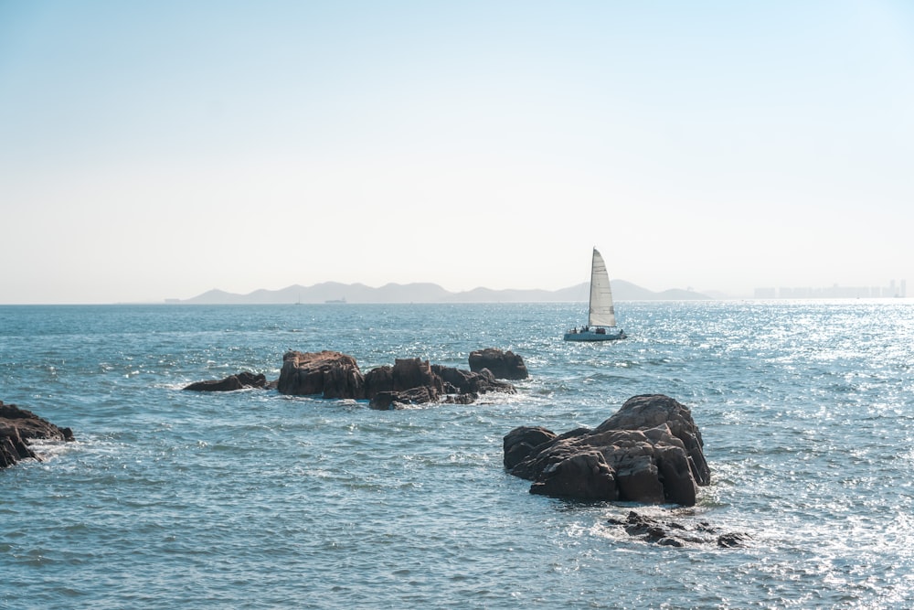 white sailboat on sea during daytime