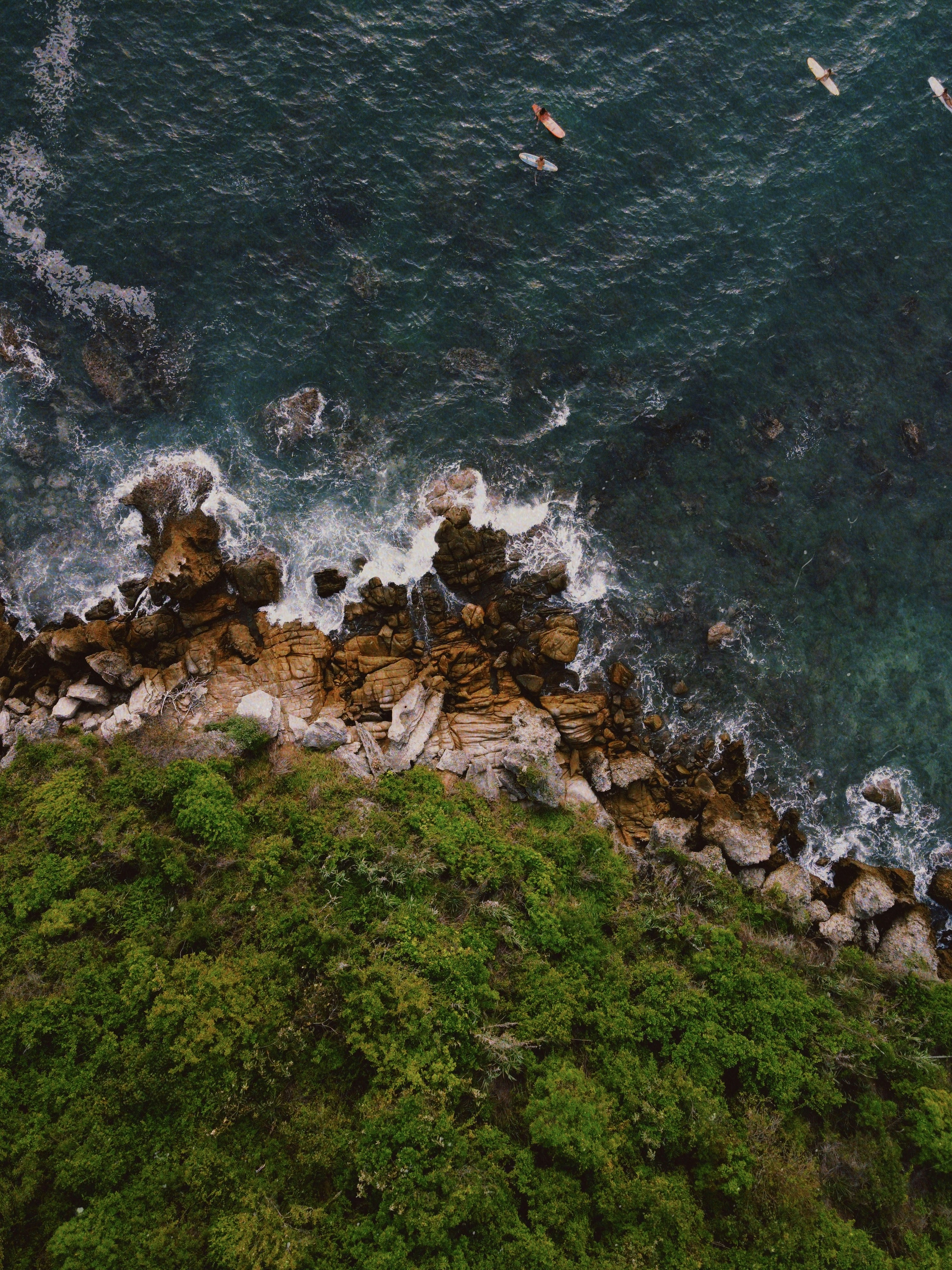brown rocks on body of water during daytime