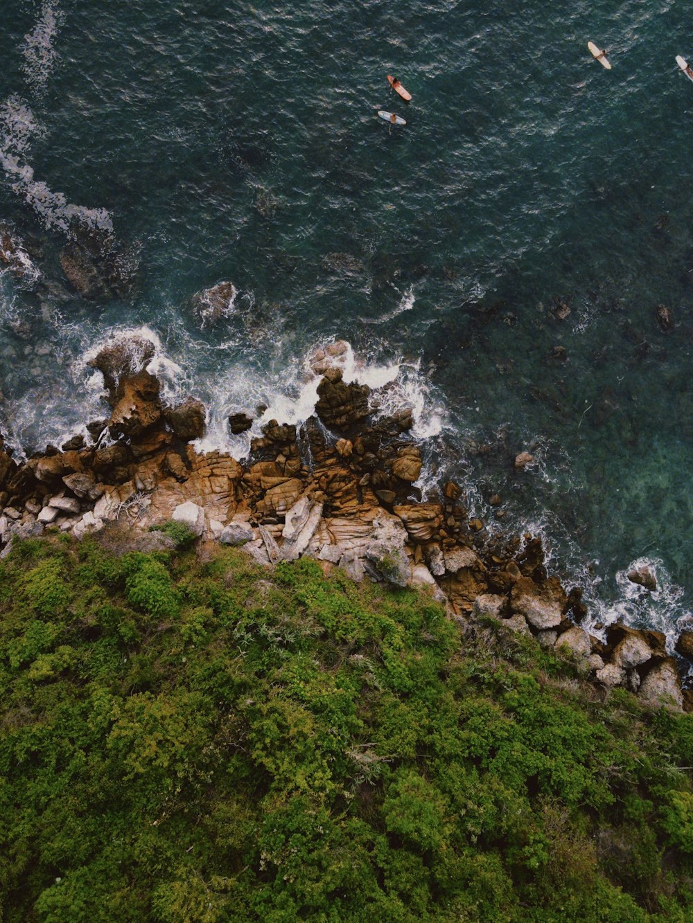 brown rocks on body of water during daytime