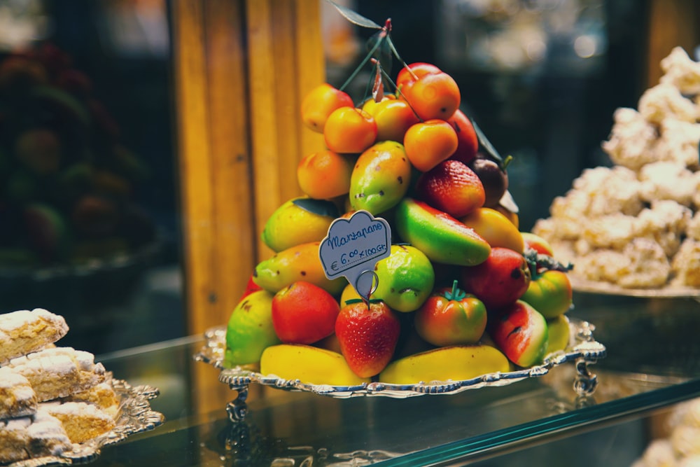 green and red apples on clear glass tray