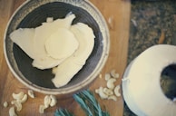 Close-up of coconut products like oil, fiber, and coconut water arranged neatly on a wooden table.