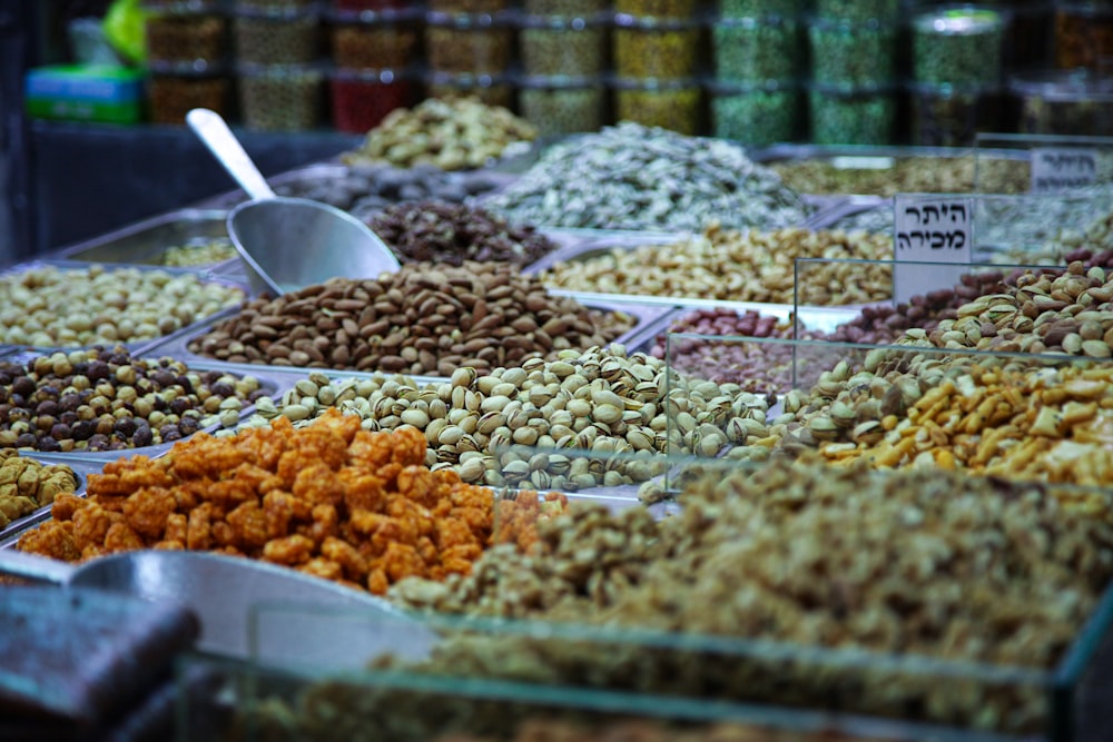 assorted color of nuts on white plastic bowls