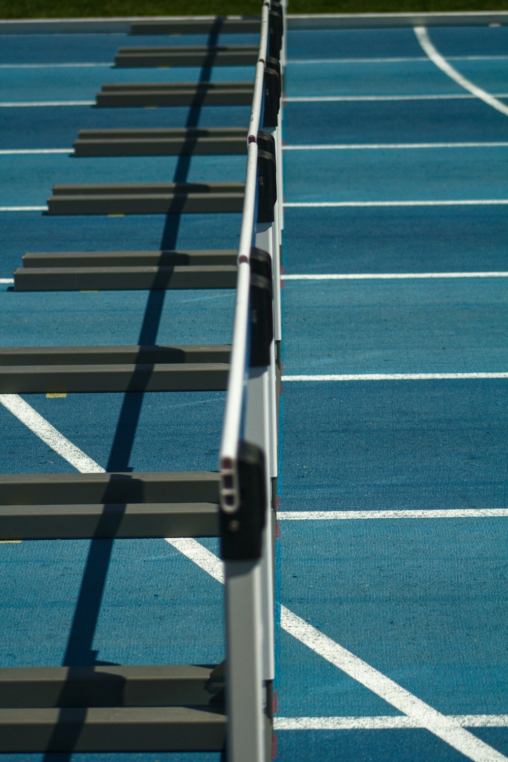 white metal fence on green and blue field