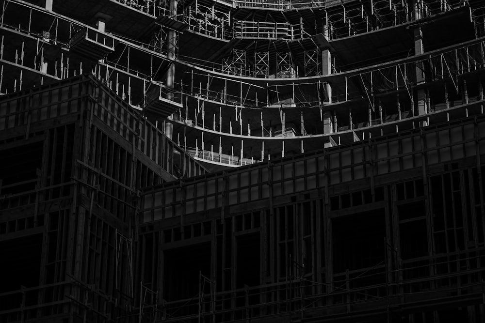 grayscale photo of building with glass windows