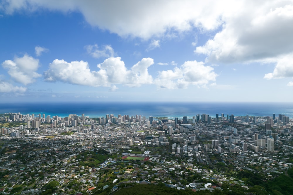 city buildings under blue sky and white clouds during daytime