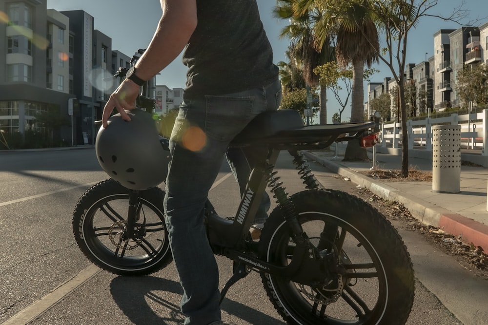 man in black t-shirt riding black motorcycle