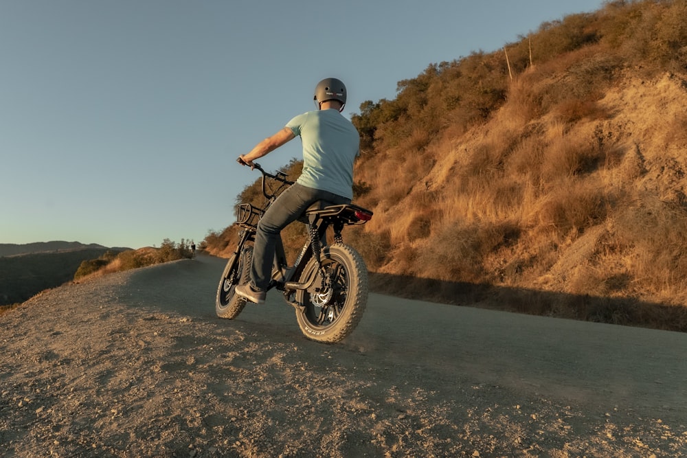 man riding electric bike for heavy riders off-road at sunset