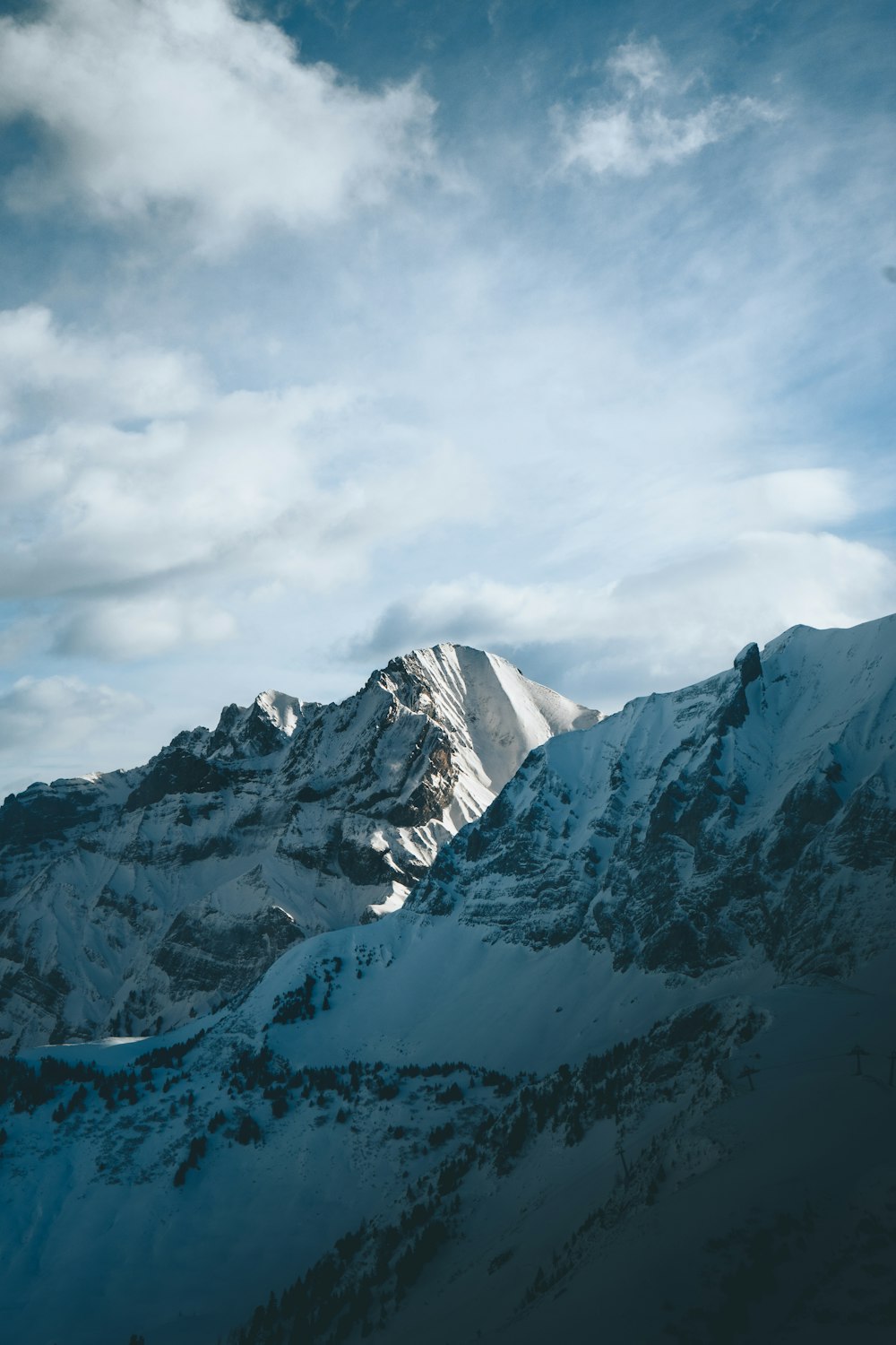 snow covered mountain under cloudy sky during daytime