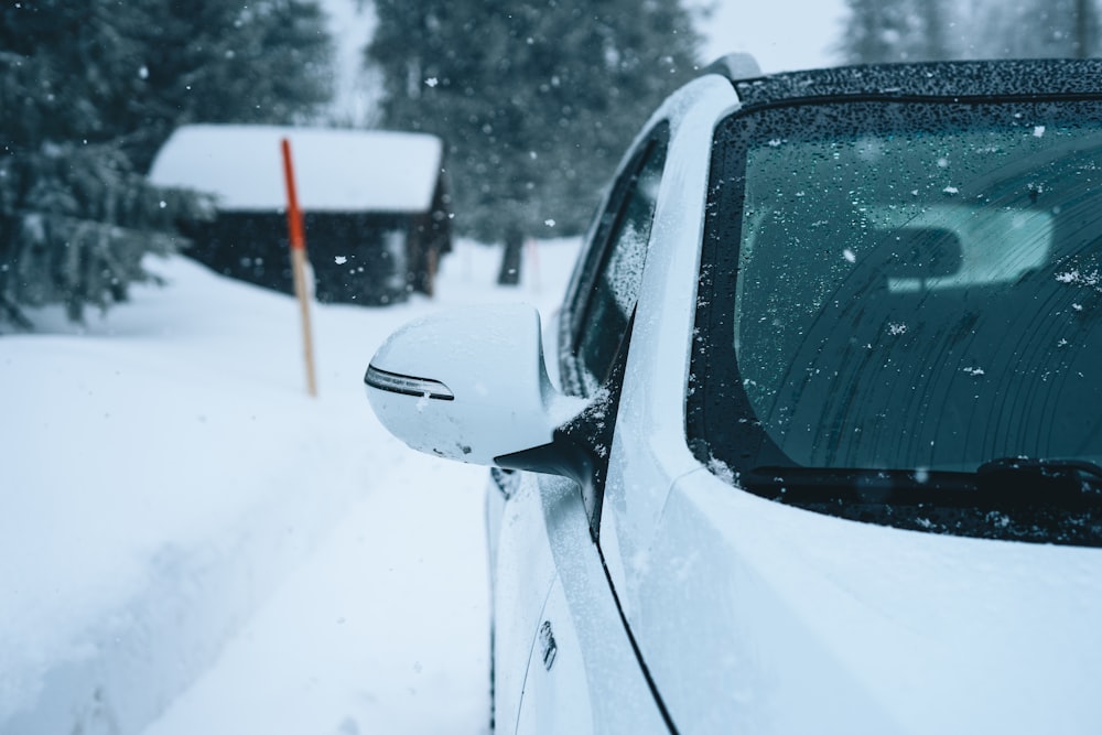 white car on snow covered road during daytime