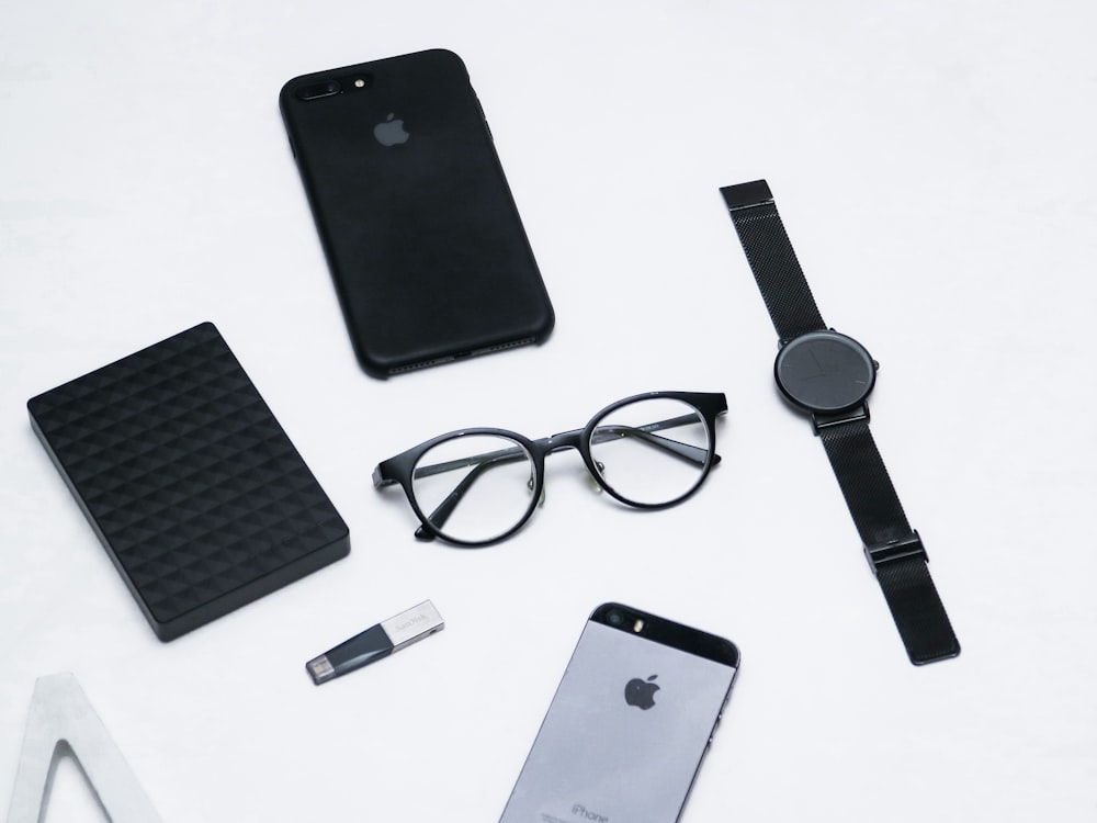 black framed eyeglasses and black iphone 5