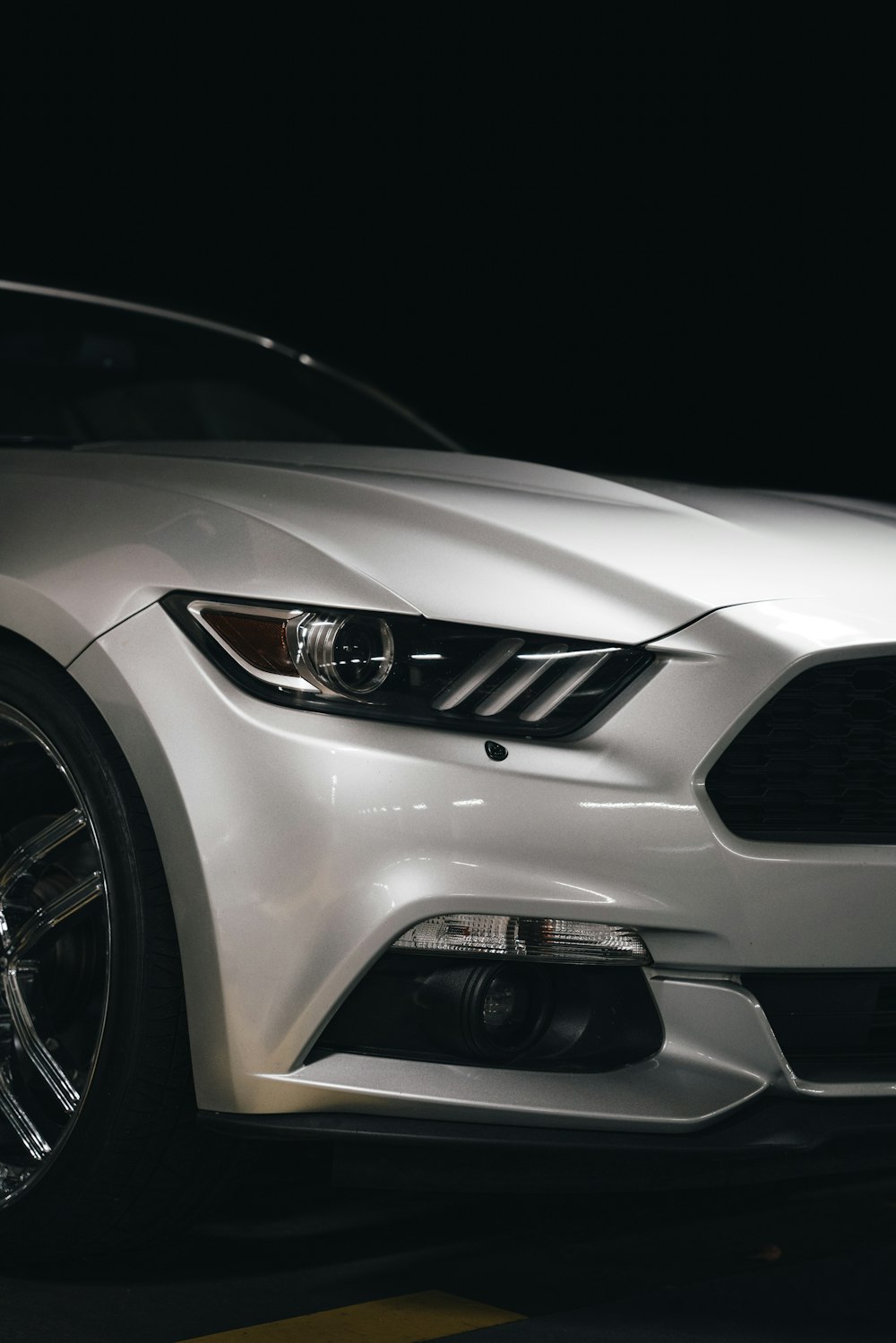 white car with black and yellow wheel