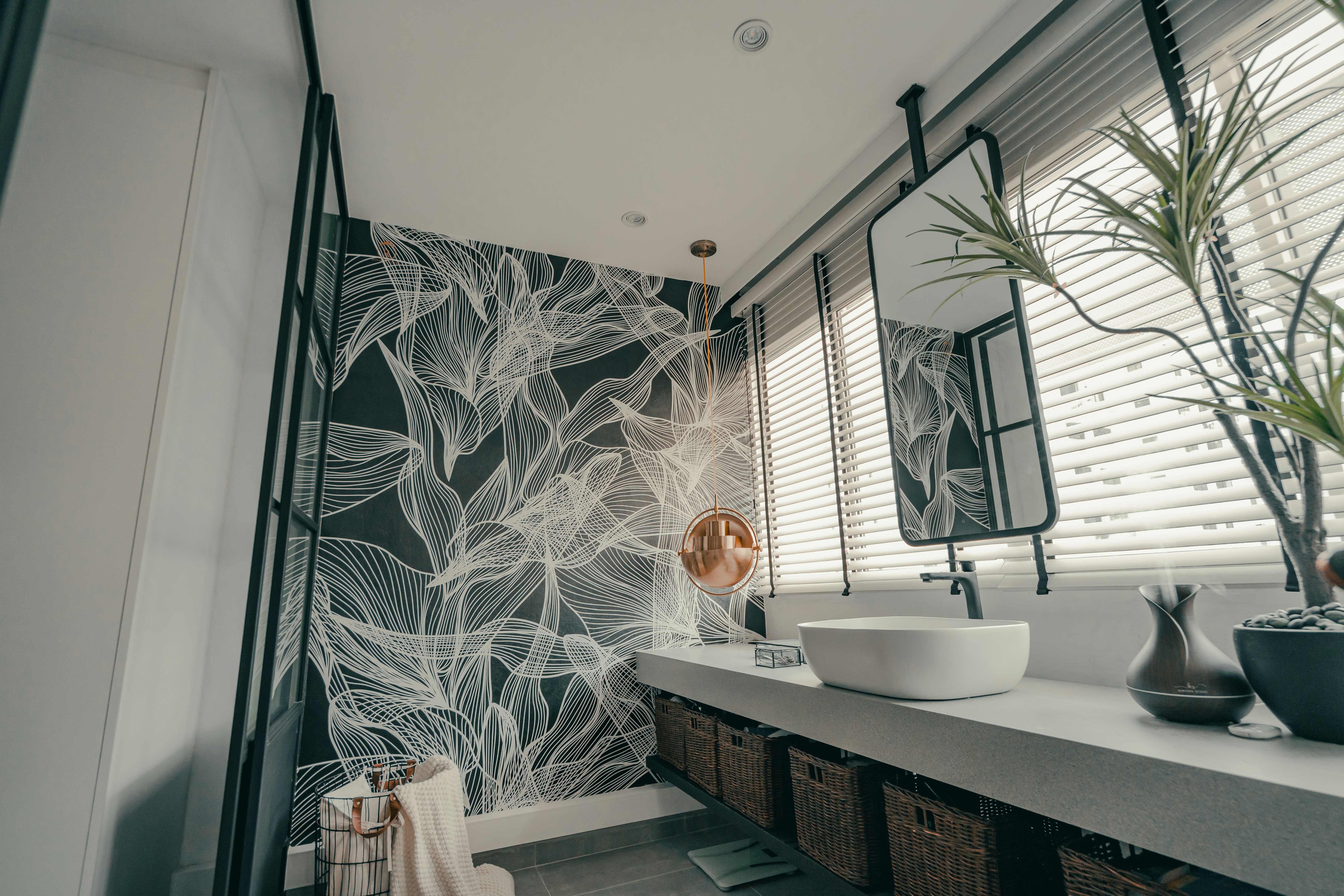 A bright, modern bathroom with organized counters and a clean shower, reflecting a well-maintained home management routine.