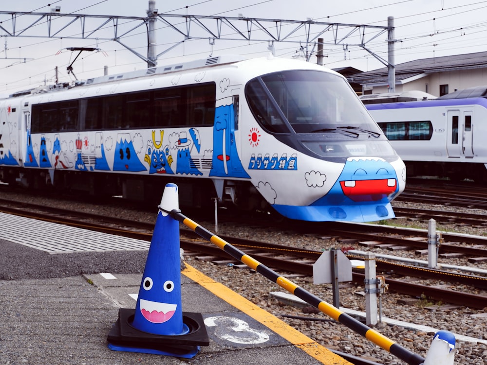 white and blue train on rail tracks