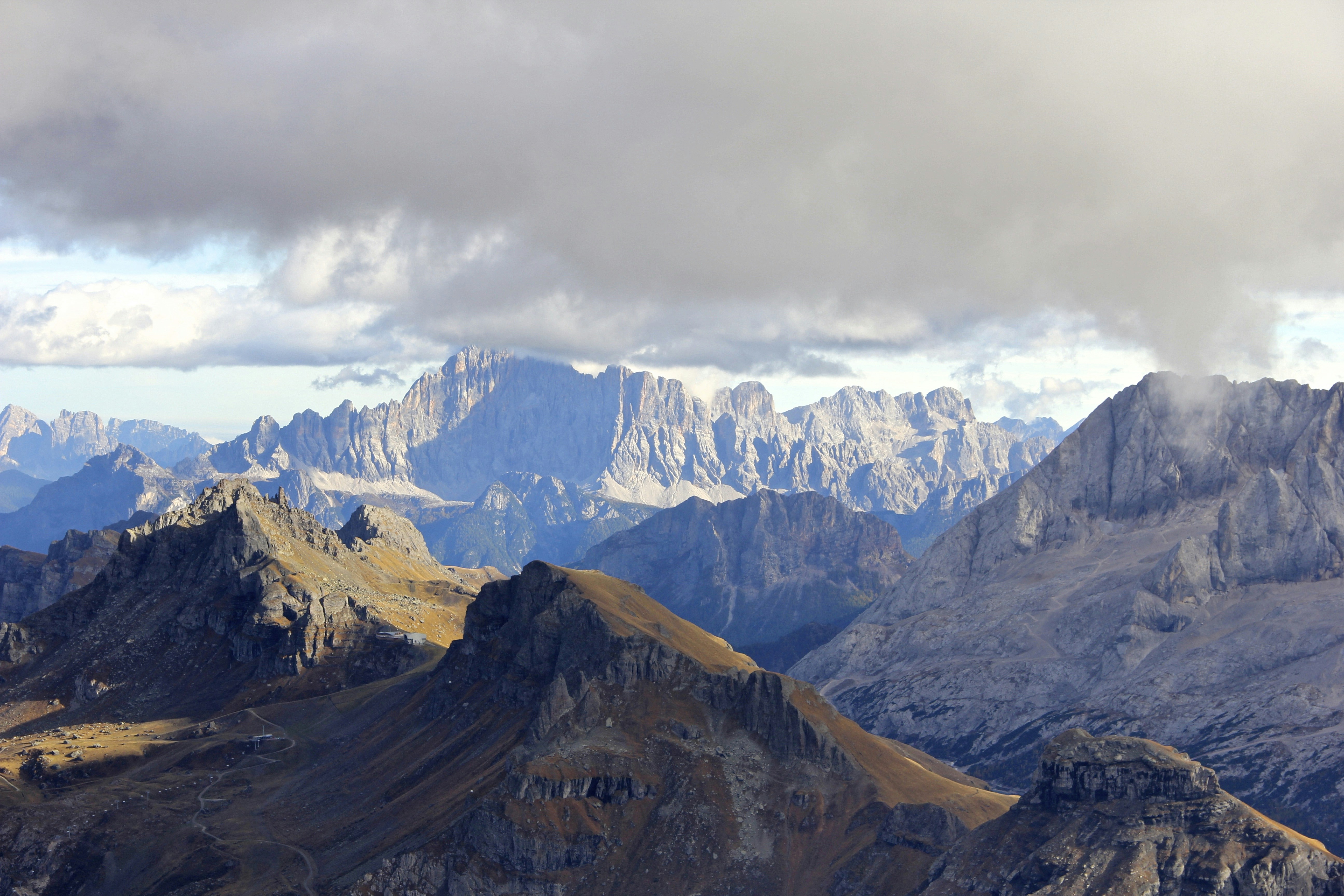 snow covered mountains under cloudy sky during daytime