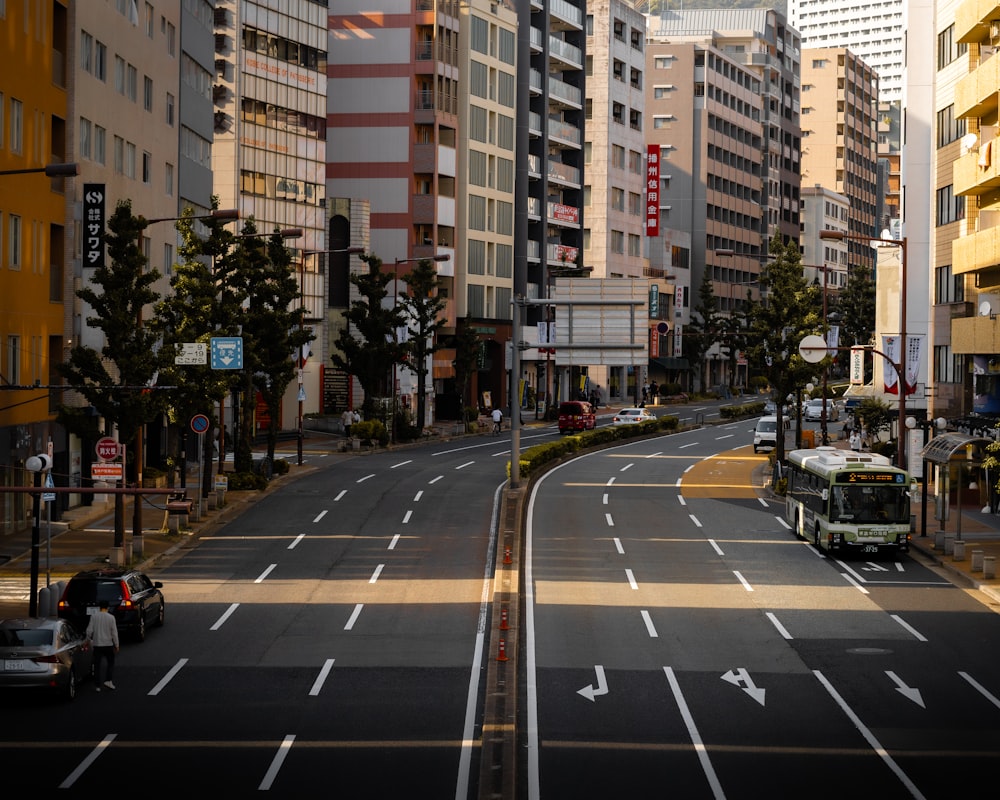 cars on road near high rise buildings during daytime