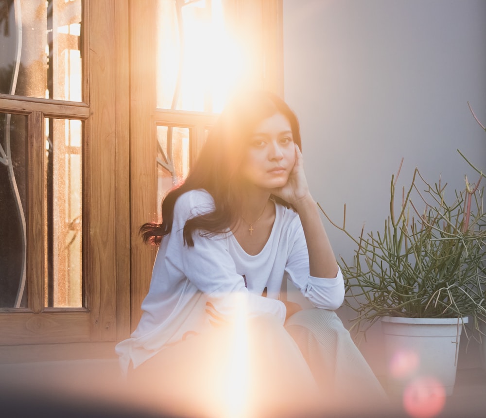 woman in white dress sitting on chair