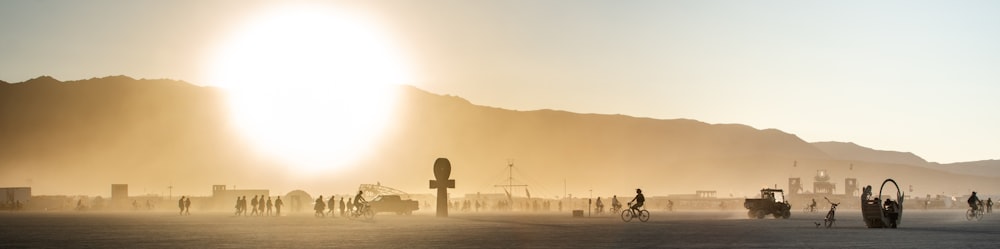 silhouette of person standing on road during sunset