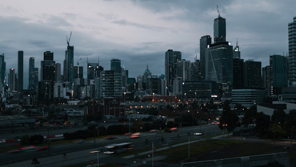 cars on road near city buildings during daytime