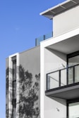 A sunlit facade of a newly completed residential complex showcasing clean architectural lines.