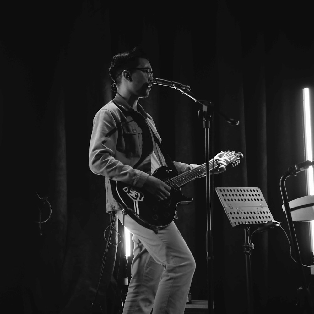 man playing guitar on stage