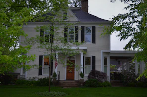 Wide shot of a traditional US home exterior finished with rich hardwood accents