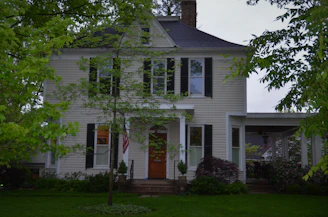 Wide shot of a traditional US home exterior finished with rich hardwood accents