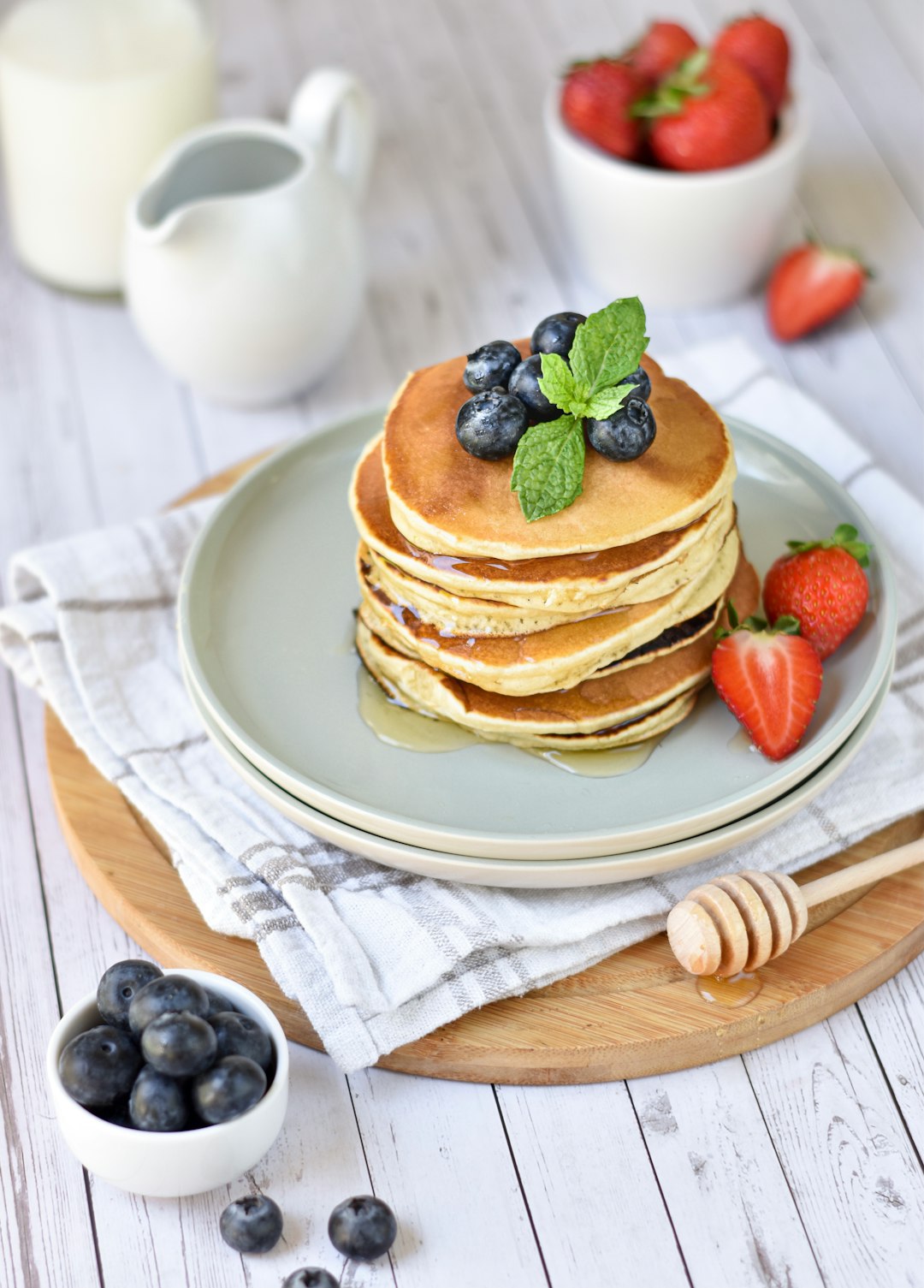 pancakes with berries on white ceramic plate