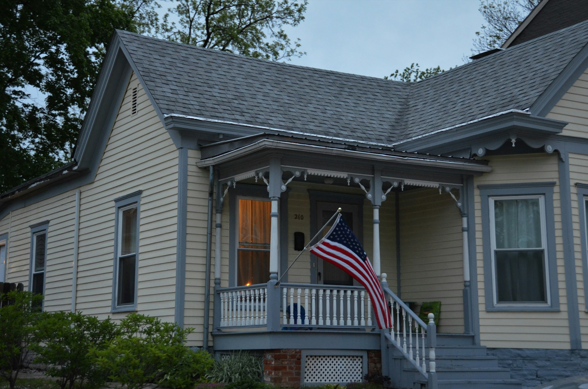 us a flag on white wooden house