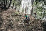 Cross-country riders navigating technical switchbacks over natural stone ledges.