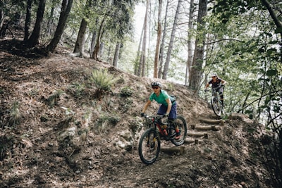 Cross-country riders navigating technical switchbacks over natural stone ledges.