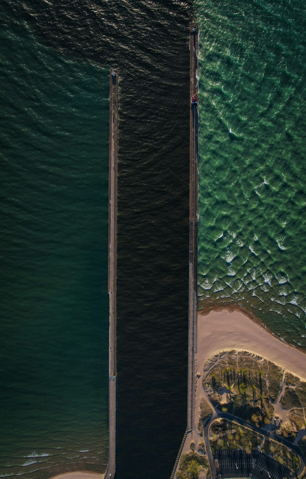 aerial view of sea and brown wooden dock during daytime