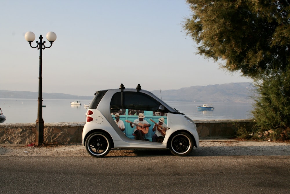 white and black volkswagen beetle parked on gray concrete road during daytime