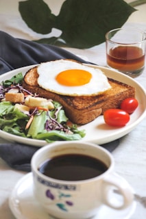 burger with egg and lettuce on white ceramic plate