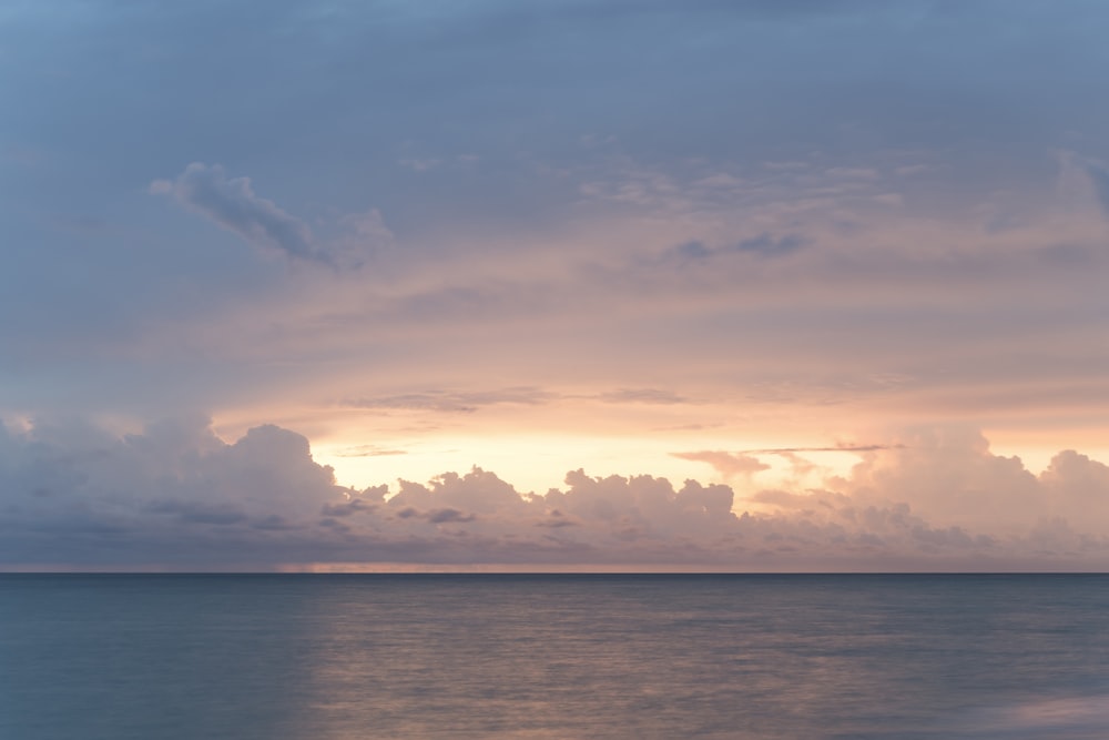 body of water under cloudy sky during daytime