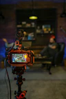 black and orange camera on black tripod