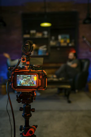 black and orange camera on black tripod