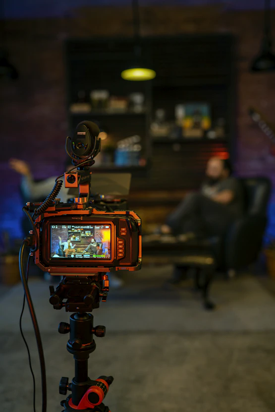 black and orange camera on black tripod
