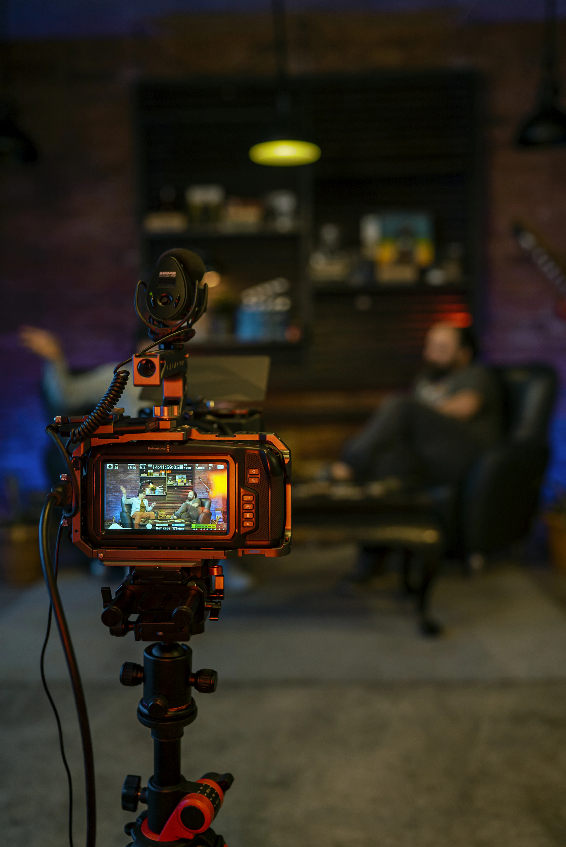 black and orange camera on black tripod
