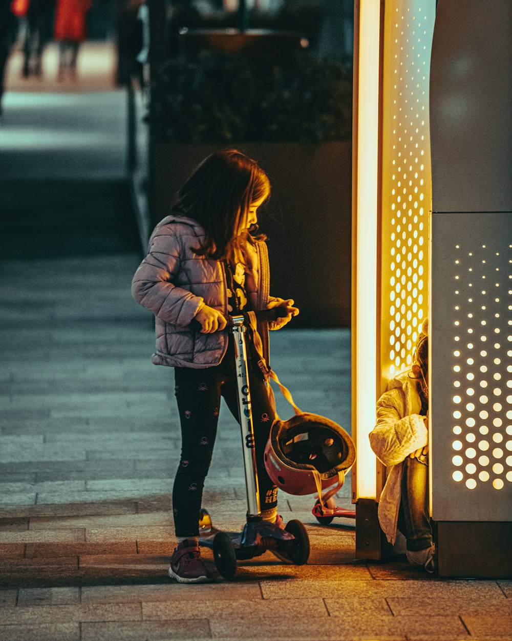 woman in brown jacket and black pants playing guitar