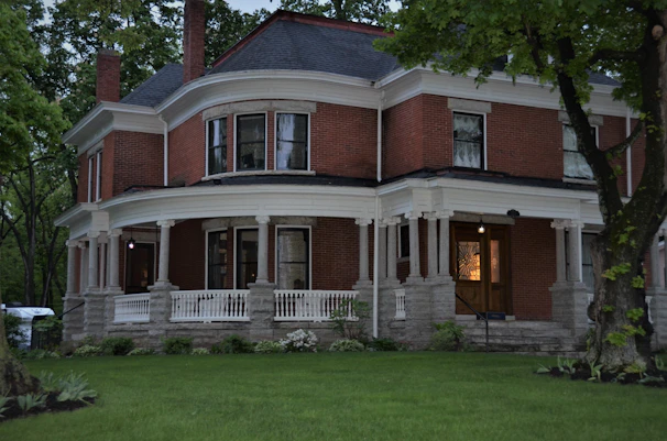 A stately family home bathed in warm evening light, symbolizing stability and legacy.