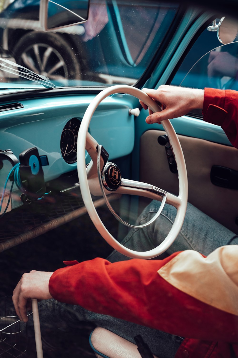 person in red long sleeve shirt driving car