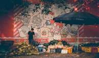 A close-up of a street vendor selling fresh tropical fruits with vibrant colors.