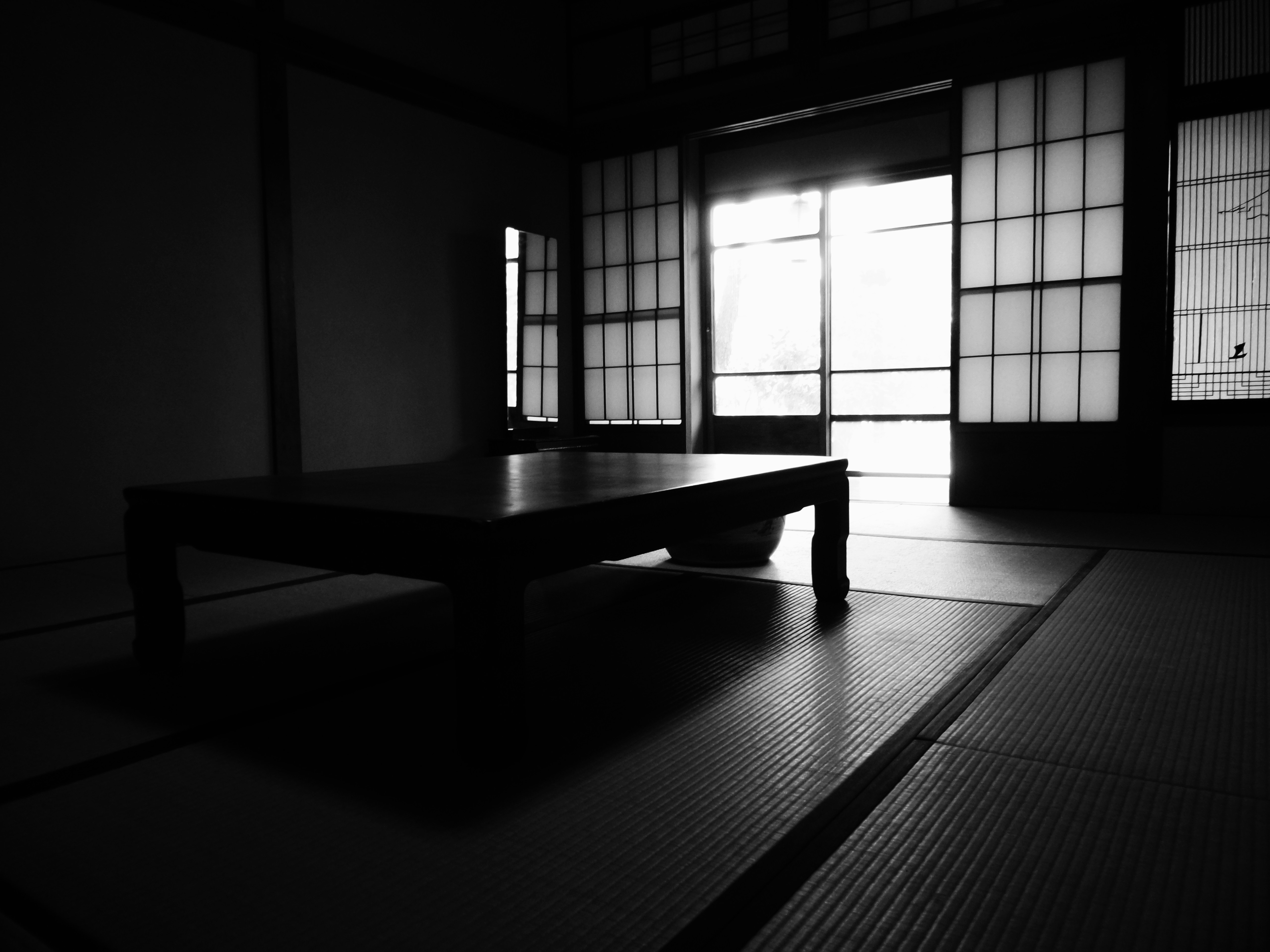 brown wooden table near window