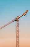 orange crane under blue sky during daytime
