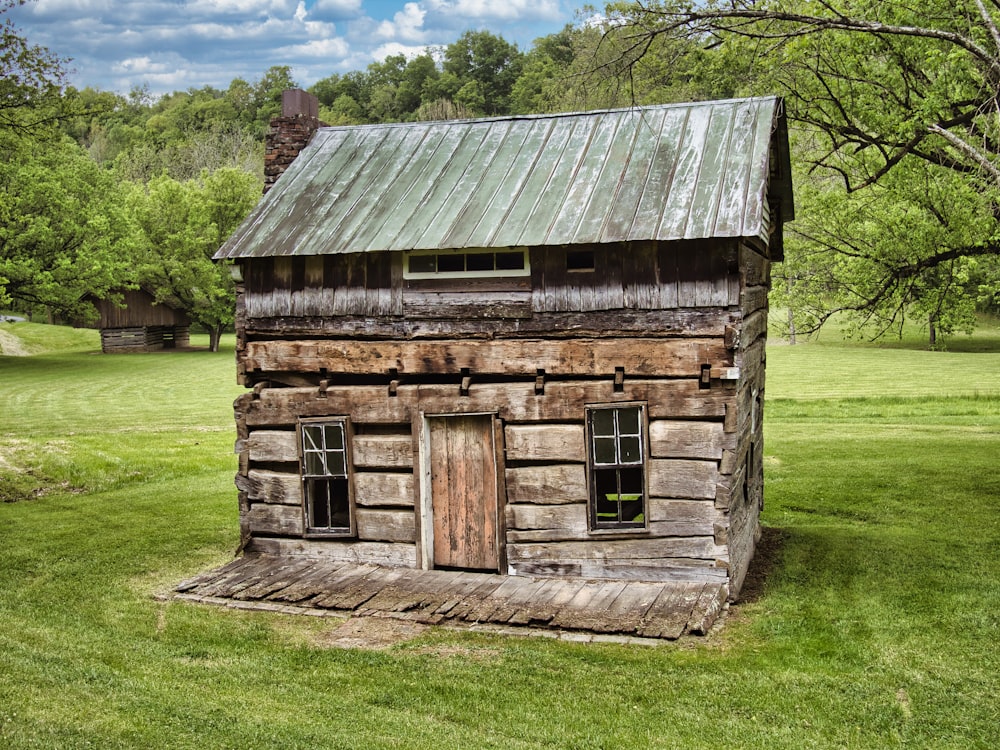 brown wooden house on green grass field