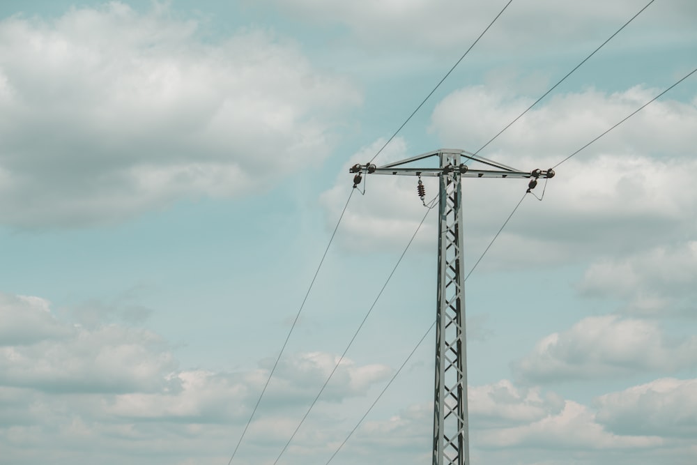 black electric post under cloudy sky during daytime