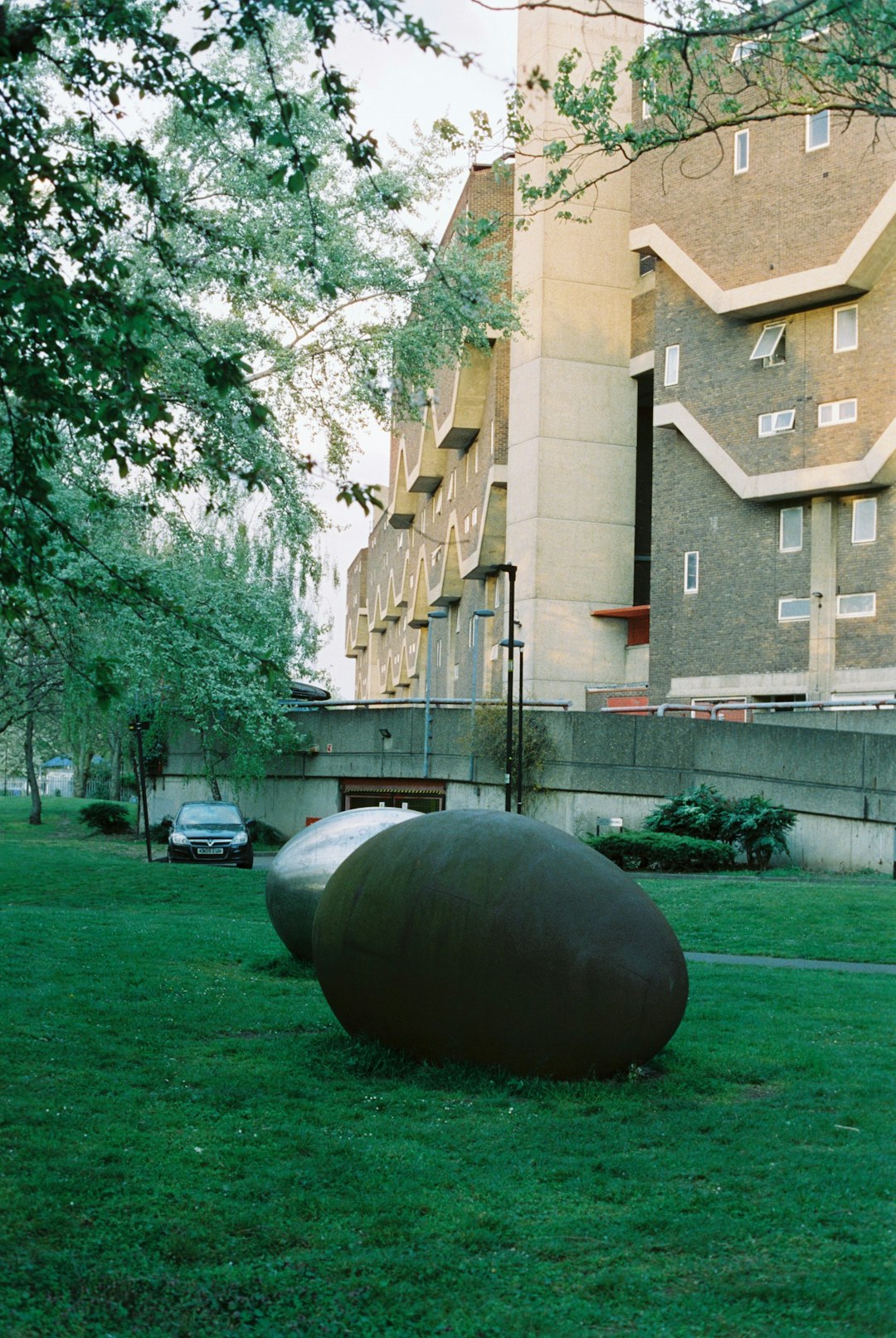 brown round ball on green grass field near brown concrete building during daytime