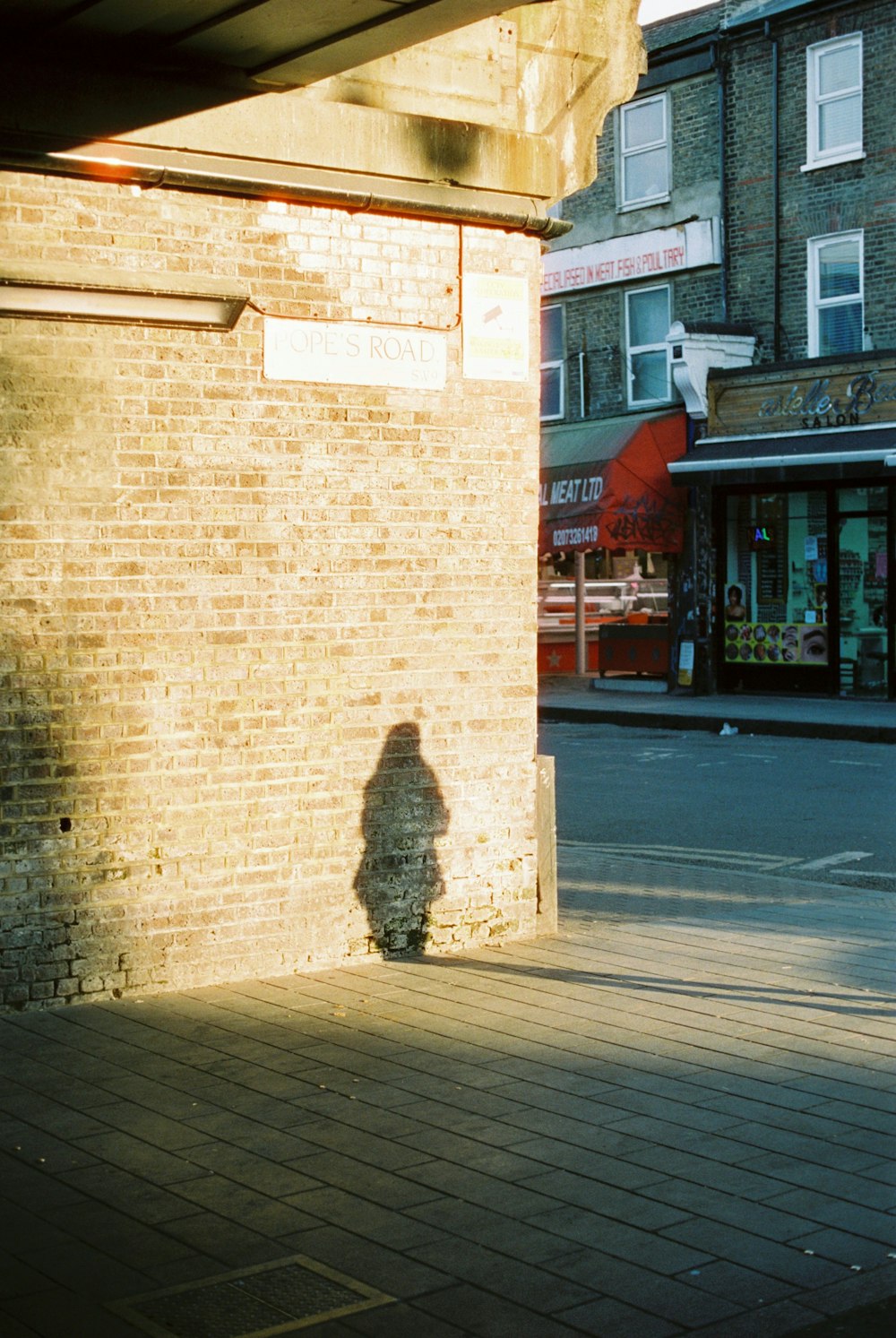 brown brick building near pedestrian lane during daytime